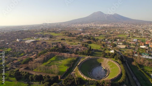 Ancient Roman amphitheater and archaeological city of pompeii at sunset. Aerial photo