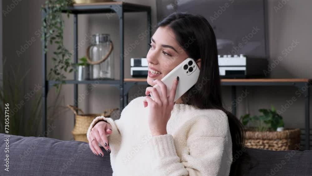 Happy young Caucasian woman talking and laughing on the phone at home apartment. Relaxation at home, remote communication, resting with phone concept. Happy young Caucasian woman talking and laughing on the phone at home apartment. Relaxation at home, remote communication, resting with phone concept.