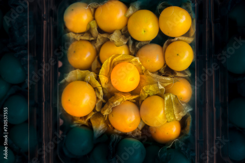 Cape gooseberries in plastic boxes on a fruit stand at Chiang Mai Province photo