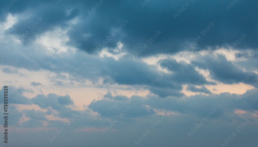 Early morning sky landscape covered with dark clouds