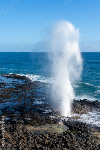 A blowhole on Kauai's south shore near Poipu, Hawaii, USA. The blowhole shoots seawater through its natural lava tube up to 50 feet in the air.