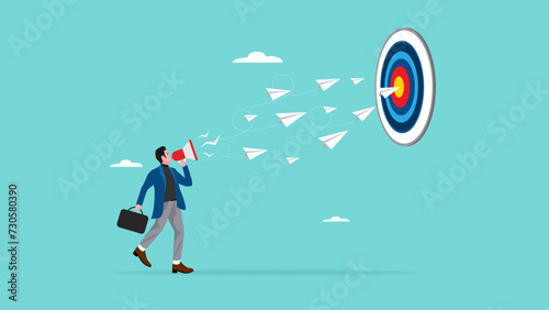 business marketing target strategy, skill or knowledge to reach target or business success, businessman controls the direction of paper airplane using megaphone to reach business target or achievement