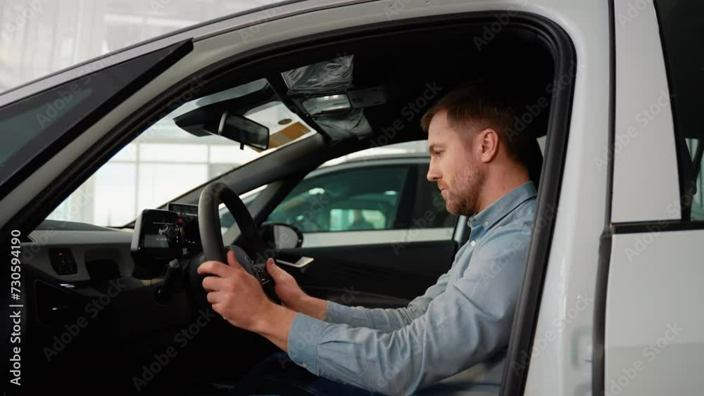 The buyer checks his new electric car before buying The buyer checks his new electric car before buying