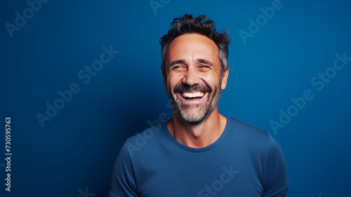 Happy smiling middle aged adult man on a solid background