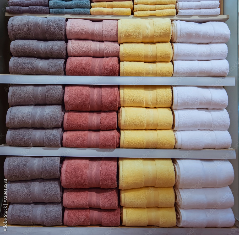 Fluffy towels were neatly folded and stacked on the shelves. Fluffy towels were neatly folded and stacked on the shelves.