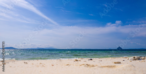 Fototapeta Naklejka Na Ścianę i Meble -  Beach sand for summer vacation concept. Beach nature and summer seawater with sunlight light sandy beach Sparkling sea water contrast with the blue sky.Beach sand for summer vacation concept.