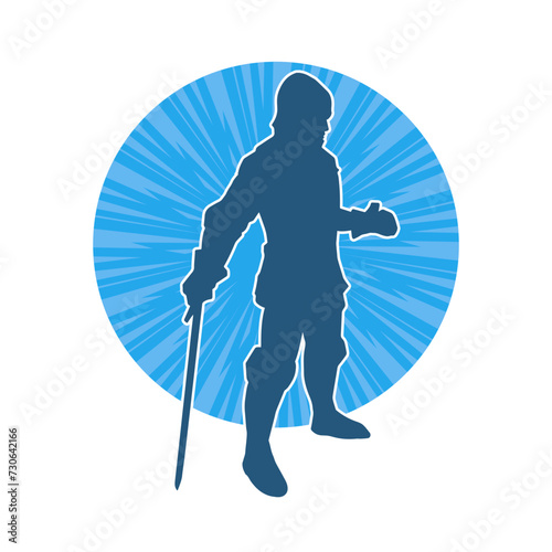 Silhouette of a male warrior wearing war armor suit in action pose using a sword weapon.
