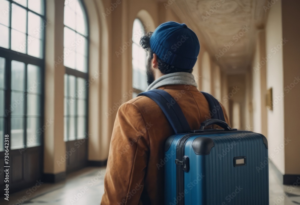 Business traveler with rolling suitcase in busy airport terminal. Business traveler with rolling suitcase in busy airport terminal.