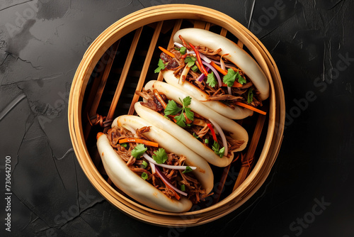 pulled beef bao buns, gua bao, in bamboo steam tray, top view photo
