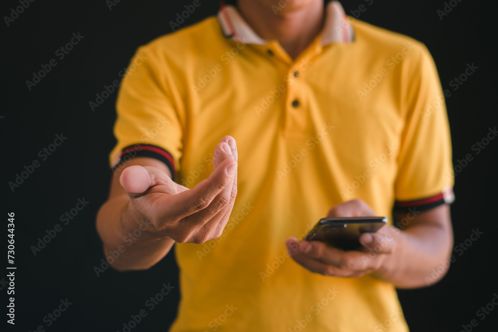 Fototapeta premium Close up footage shows a man using his phone, spreading his hands out.