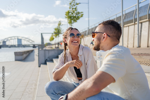 Friendship, flirting and couple with sunglasses in city at street laughing. Love, friends and romance, urban dating and freedom.