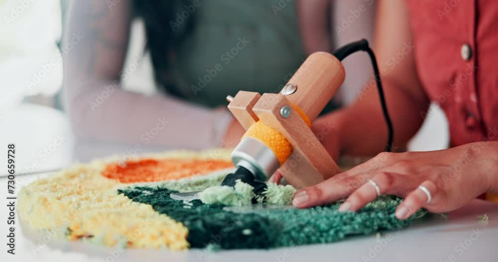 Hands, team or tufting with rug carver, design or shave textile together at table. Carpet, trimmer or closeup of professional with fabric, tools or electric machine to craft in manufacturing workshop