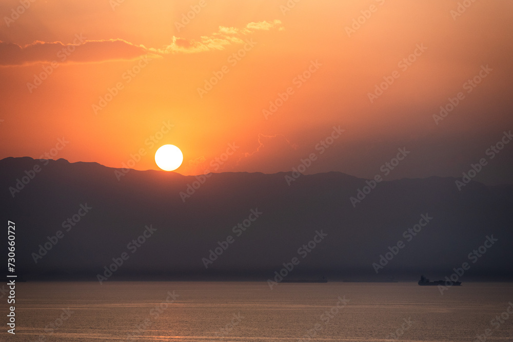Beautiful, red, sunset sky over the Egyptian coast. View from cargo ship sailing through Suez Canal. Beautiful, red, sunset sky over the Egyptian coast. View from cargo ship sailing through Suez Canal.