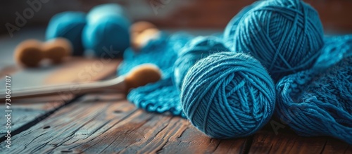 Blue yarn on a wooden table in a crochet and knitting workshop.