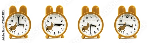close up of a set of cute brown alarm clocks showing the time; 3, 3.15, 3.30 and 3.45 p.m dan a.m. Isolated on white background

