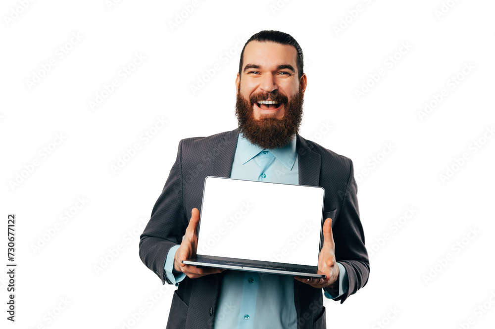Confident smiling bearded man in jacket shows a blank screen of a laptop. Confident smiling bearded man in jacket shows a blank screen of a laptop.