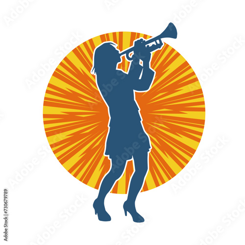 Silhouette of a woman musician playing trumpet brass musical instrument. © anom_t