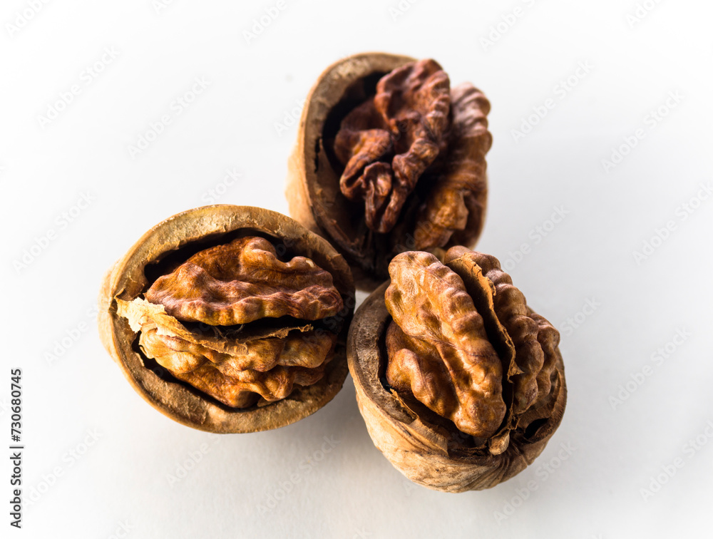 Three open walnuts on a white background Three open walnuts on a white background