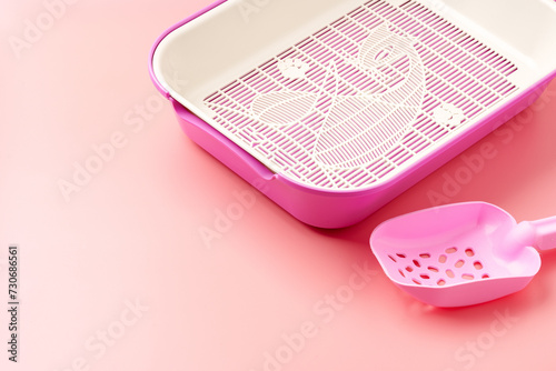 Empty pet litter box on pink background photo
