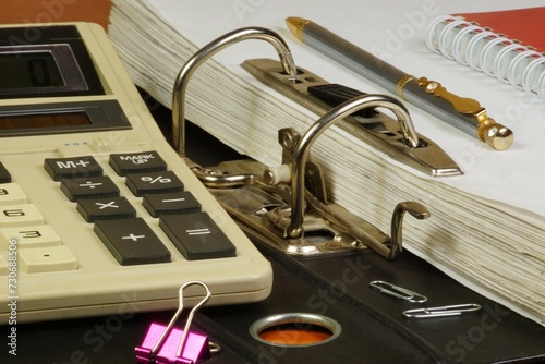 Calculator and accountant's folder. Financial analysis and budget profit planning. photo