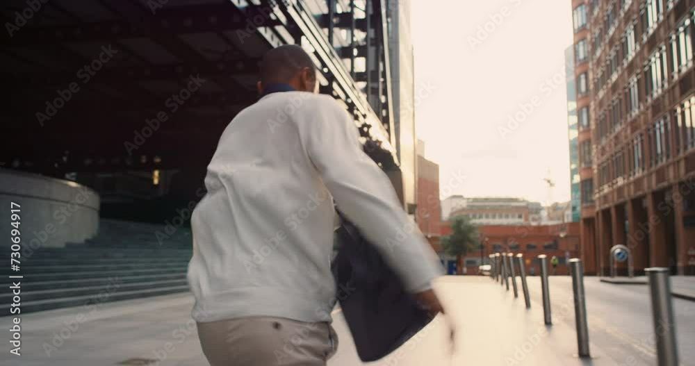 Running, scared and business man in city in rush, hurry and worried to be late for work. Robbery, anxiety and back of person with panic, stress and fear for chase, danger and stalker in street
