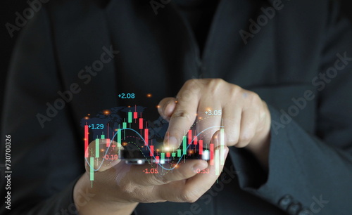 Finger pointing at market analysis with digital monitor.Businessman checking stock market data.Finance and stock exchange concept
