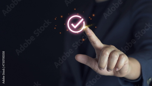 Businessman hand touching to tick correct sign mark on checkbox from checklist , Business selection choice concept.