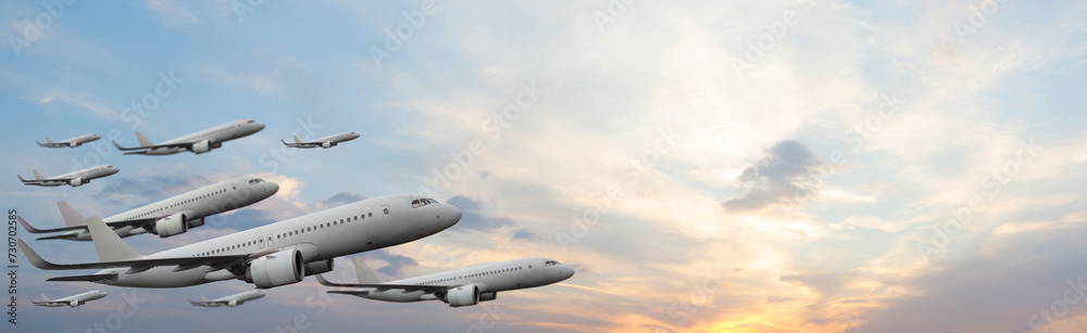 Planes flying on sunset sky with white cloud. Flight, fly and aircraft concept.