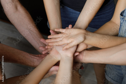 Group Of People Stacking Their Hands Together. Family  unity and team concept