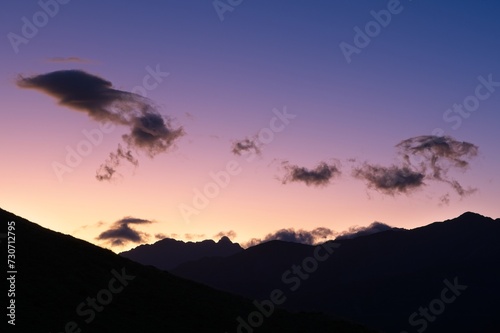 Vibrant Sunset Palette: A Spectacular Sky Painted with Multicolored Hues, showing the Silhouettes of Mountain Peaks