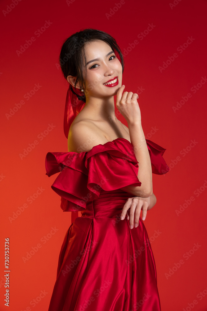 New Year atmosphere, an Asian young woman against a red background New Year atmosphere, an Asian young woman against a red background