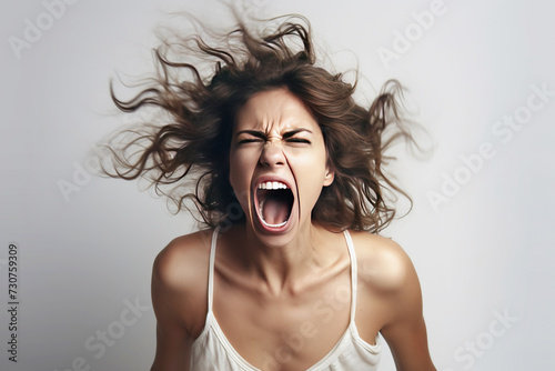 Close-up of a young woman angry, screaming in a scandal, white background isolate.