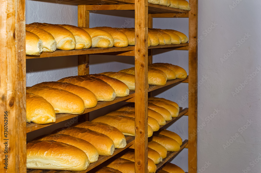 Fresh bread resting on shelves before transportation to the shops.