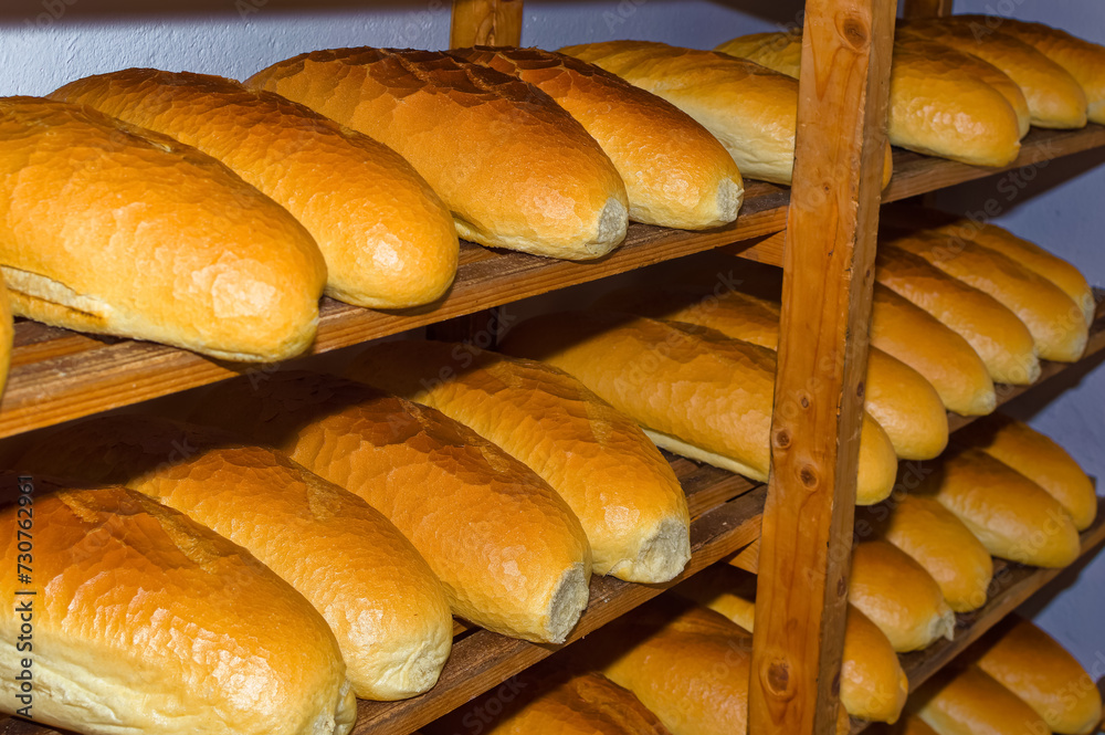 Fresh bread resting on shelves before transportation to the shops.
