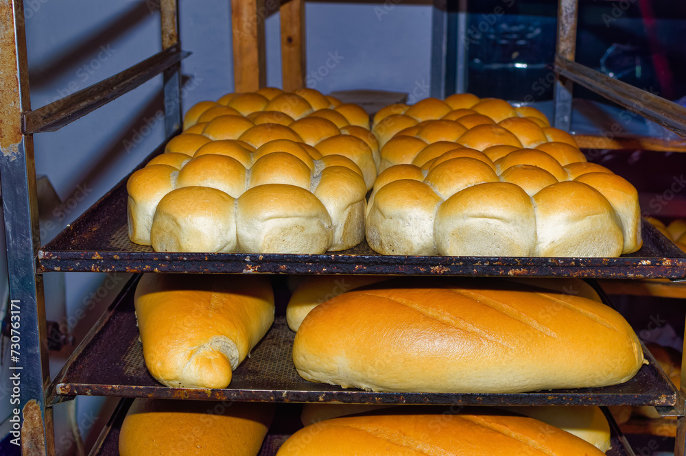 Fresh bread resting on shelves before transportation to the shops.
