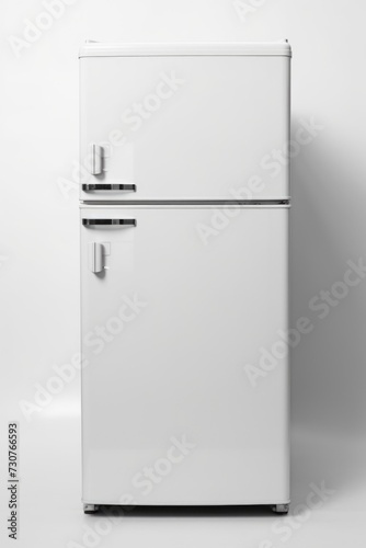 A white refrigerator freezer positioned against a white wall. Can be used for home appliance advertisements or interior design concepts