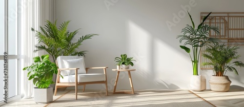 A cozy living room adorned with a comfortable chair  a stylish table  and green potted plants adding a natural touch to the space.