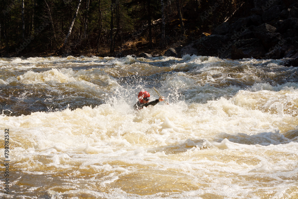Adventure Seeker Man Kayaking in River with Thrilling White Water Rapids and Scenic Rock Formations