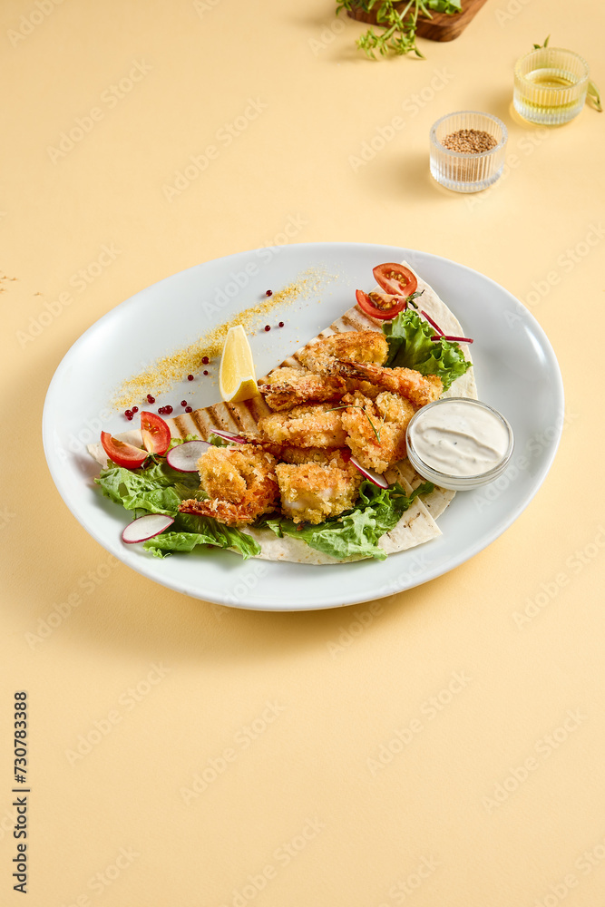 Tempura shrimp with tartar sauce on a bed of lettuce, presented on a white plate with lemon and tomato accents, against a soft yellow backdrop Tempura shrimp with tartar sauce on a bed of lettuce, presented on a white plate with lemon and tomato accents, against a soft yellow backdrop