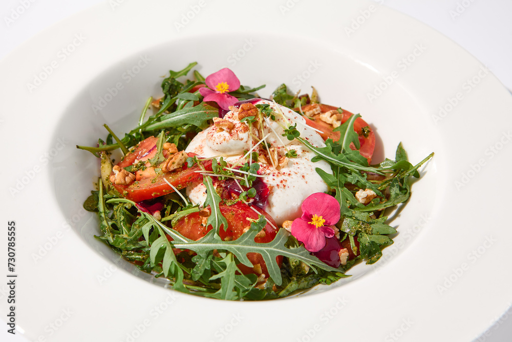 Italian salad with burrata, tomatoes, and arugula, elegantly arranged and garnished with edible flowers Italian salad with burrata, tomatoes, and arugula, elegantly arranged and garnished with edible flowers