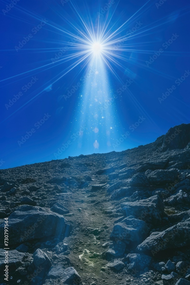 Road to success, bright beam of light climbs to the top of the mountain which is illuminated by light, view from afar