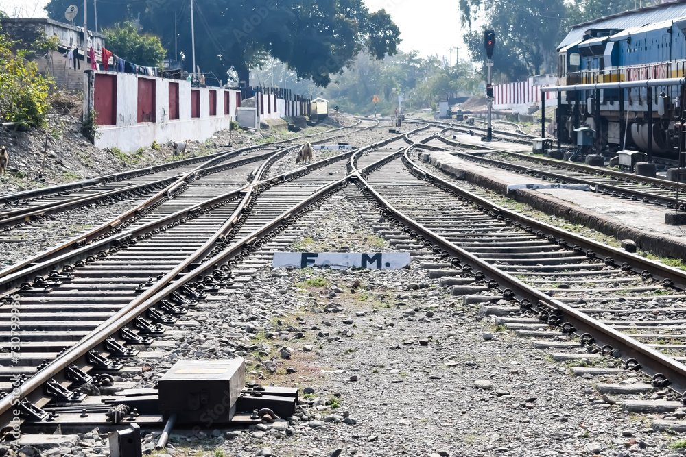 View of train Railway Tracks from the middle during daytime at Kathgodam railway station in India, Toy train track view, Indian Railway junction, Heavy industry View of train Railway Tracks from the middle during daytime at Kathgodam railway station in India, Toy train track view, Indian Railway junction, Heavy industry