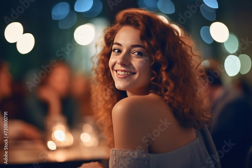 A beautiful woman enjoying while having dinner with friends at night party.