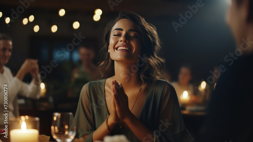 Woman Applauding Amidst Soft Focus and Cinematic Ambiance at Dinner Party © wiparat