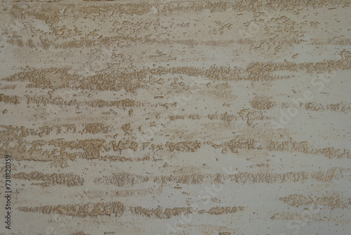 Close shot of beige semi-smooth wall with stucco lace finish