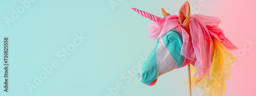 
children's toy - the head of a beautiful fabric horse on a stick isolated on a pastel background. hobbyhorsing concept photo