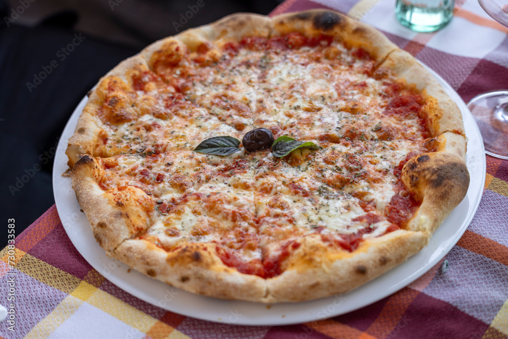 Pizza, dish of Italian origin usually consisting of a round pie with various toppings and melted cheese
