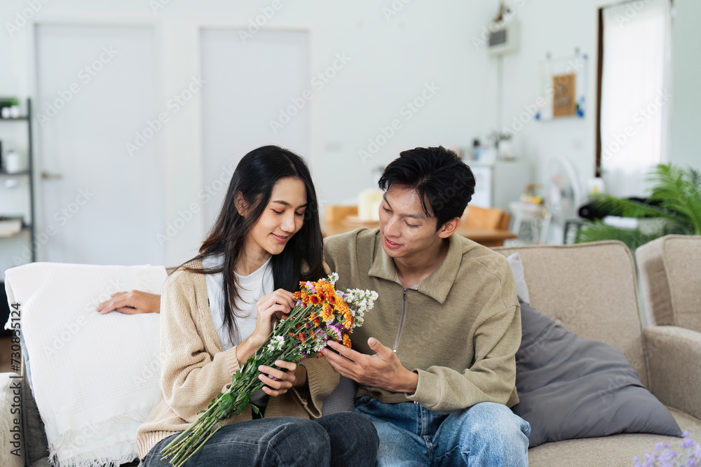 Young couple Hug and giving flower on Valentine's Day. Romantic day together. Valentine's Day concept Young couple Hug and giving flower on Valentine's Day. Romantic day together. Valentine's Day concept