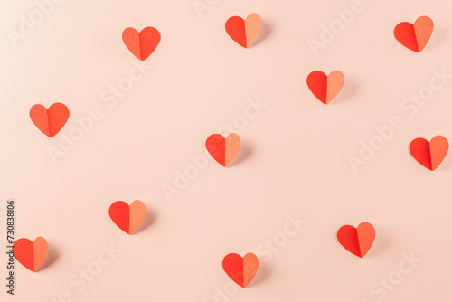 Happy Valentine's day concept. Symbol of love paper art with copy space for text, handmade red paper hearts shape cutting pastel pink background, Mother's Day
