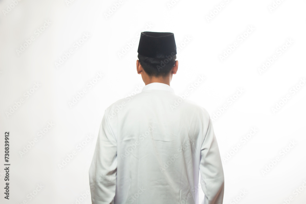 Asian Muslim Muslim man standing straight and back to camera, isolated white studio, muslim man concept